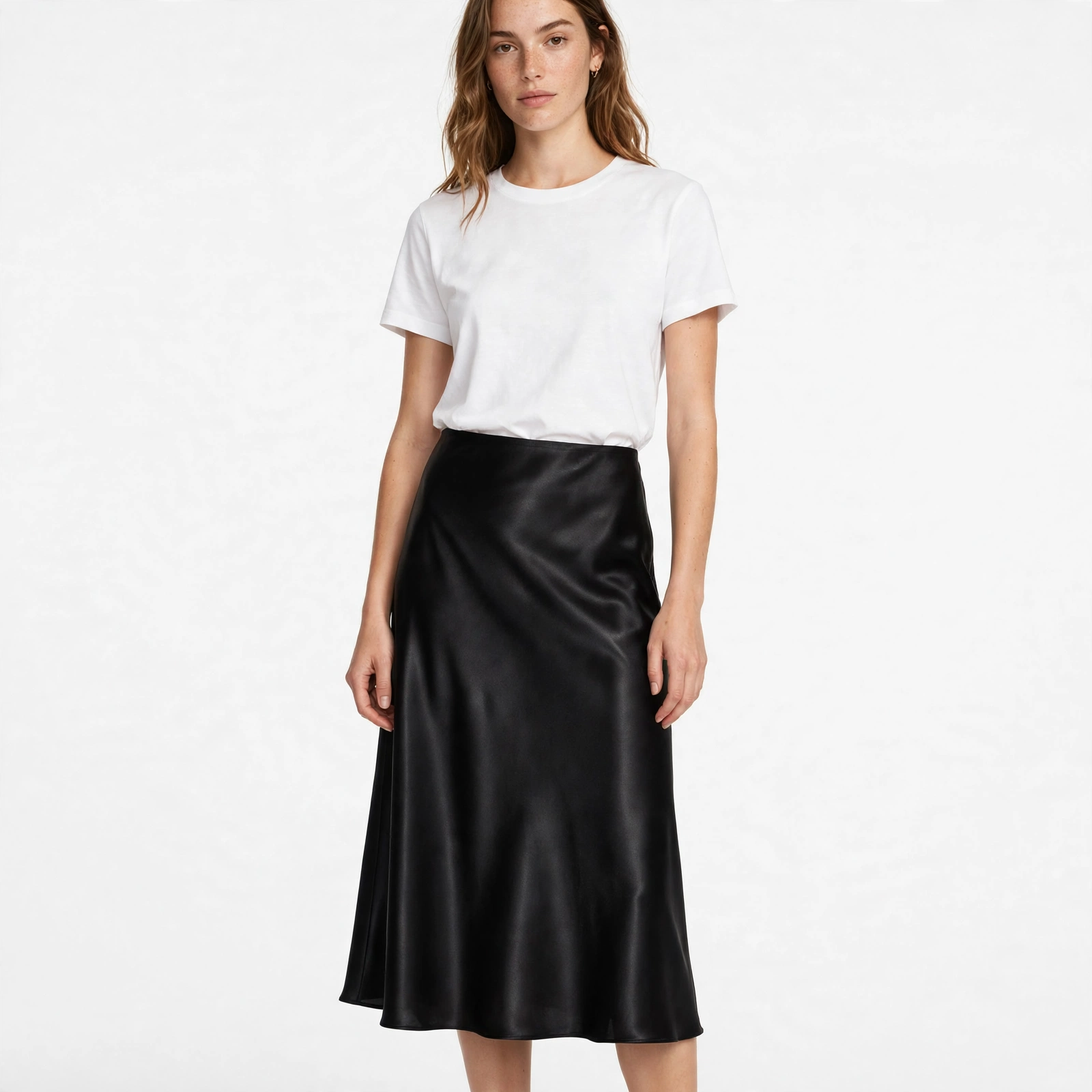 Black satin midi skirt with strong glossy highlights