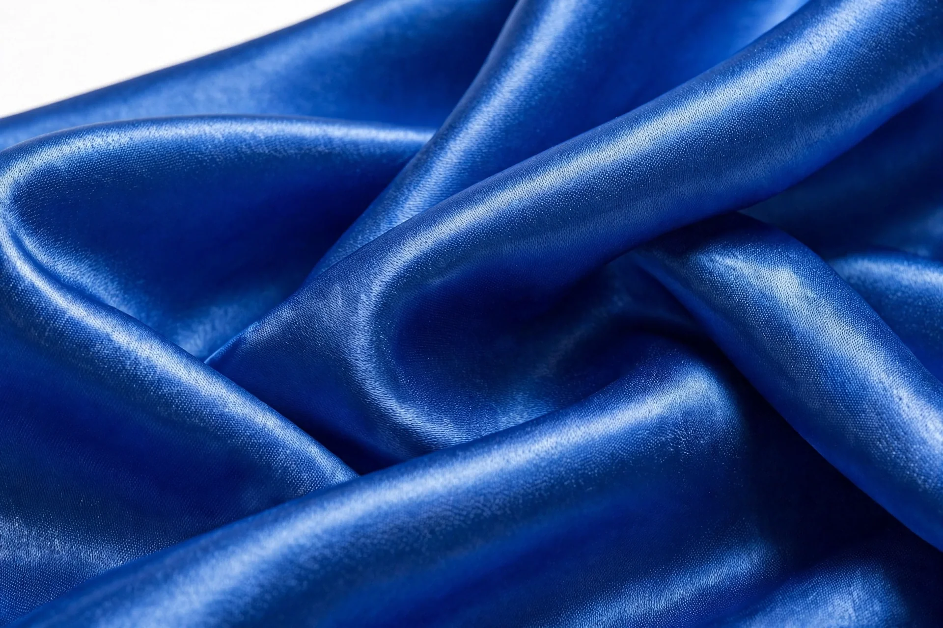Close-up of cobalt blue satin fabric drape and weave texture
