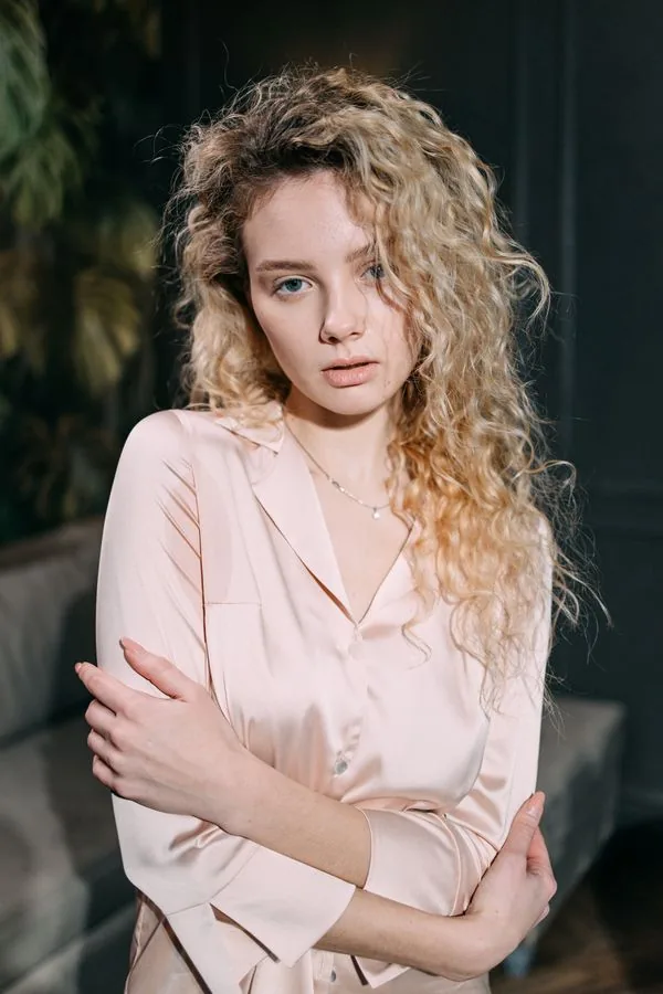 Blush pink charmeuse satin blouse in natural daylight