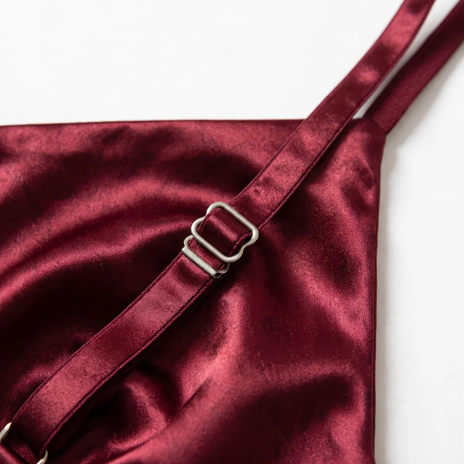 Close-up of adjustable strap on burgundy satin camisole