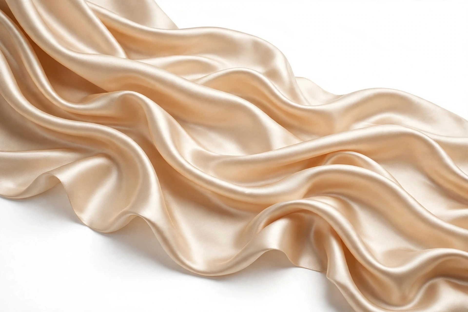 Champagne charmeuse satin flowing in soft waves