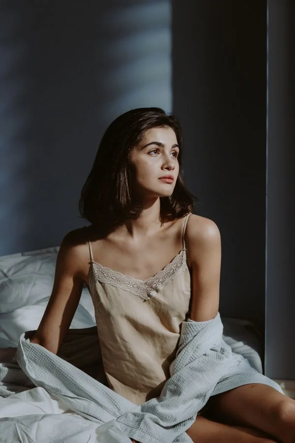 Woman wearing a champagne satin camisole