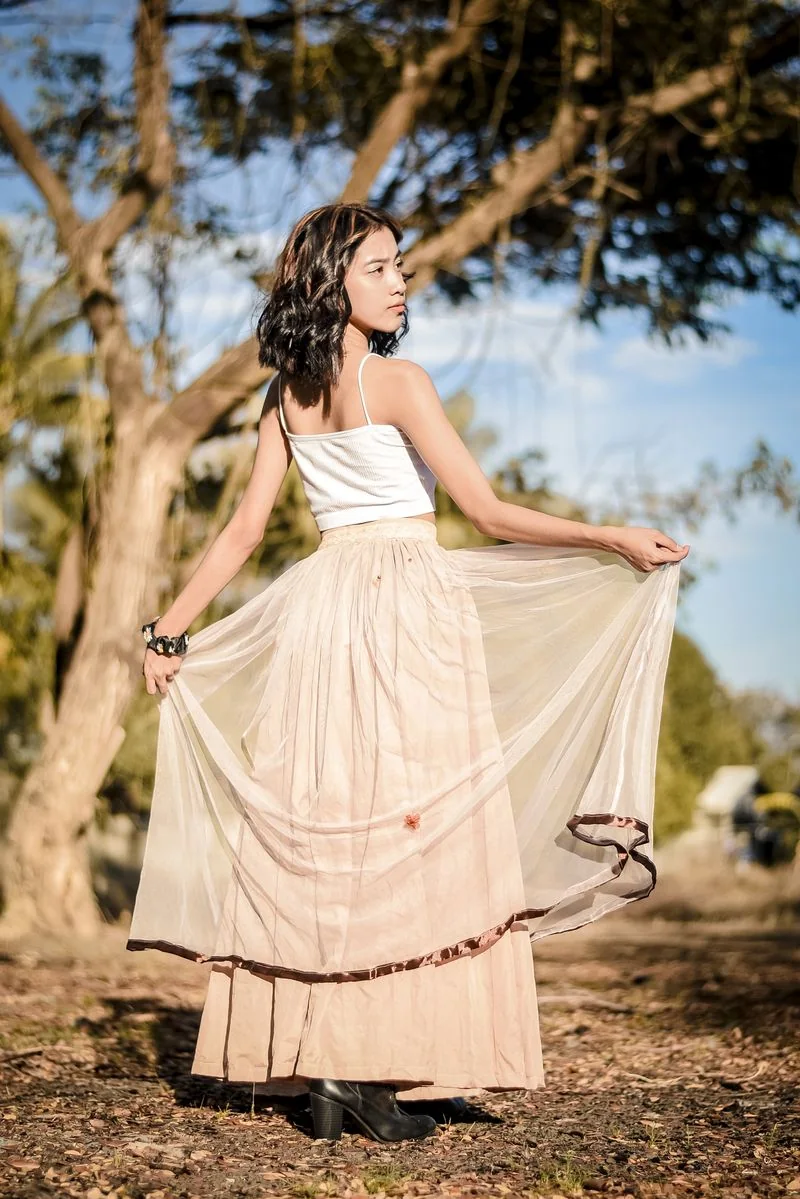 Champagne satin maxi skirt with glossy highlights in daylight