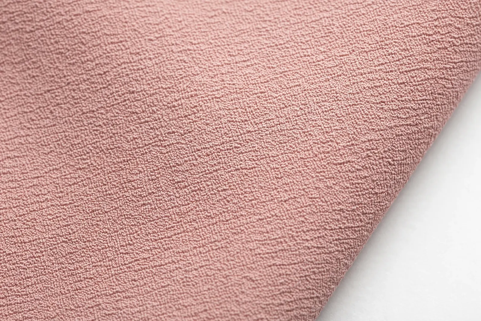 Close-up of the matte pebbled crepe texture on crepe satin's reverse side