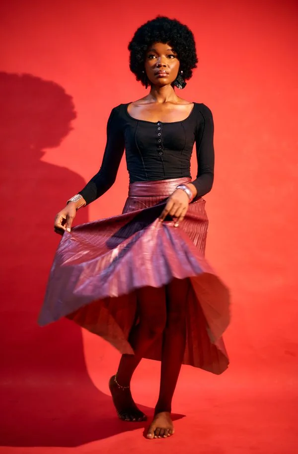 Deep rose satin skirt styled with black heels for evening
