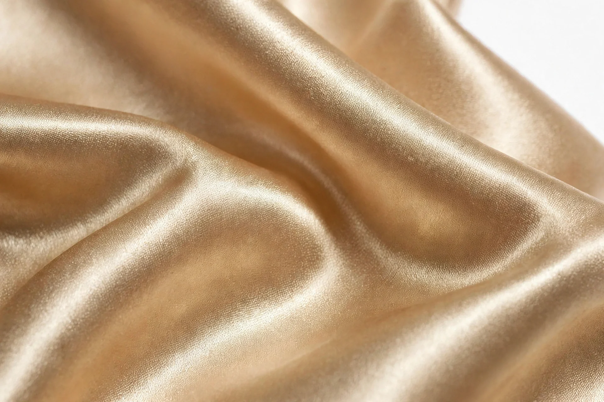 Champagne satin fabric close-up showing weave and golden gloss