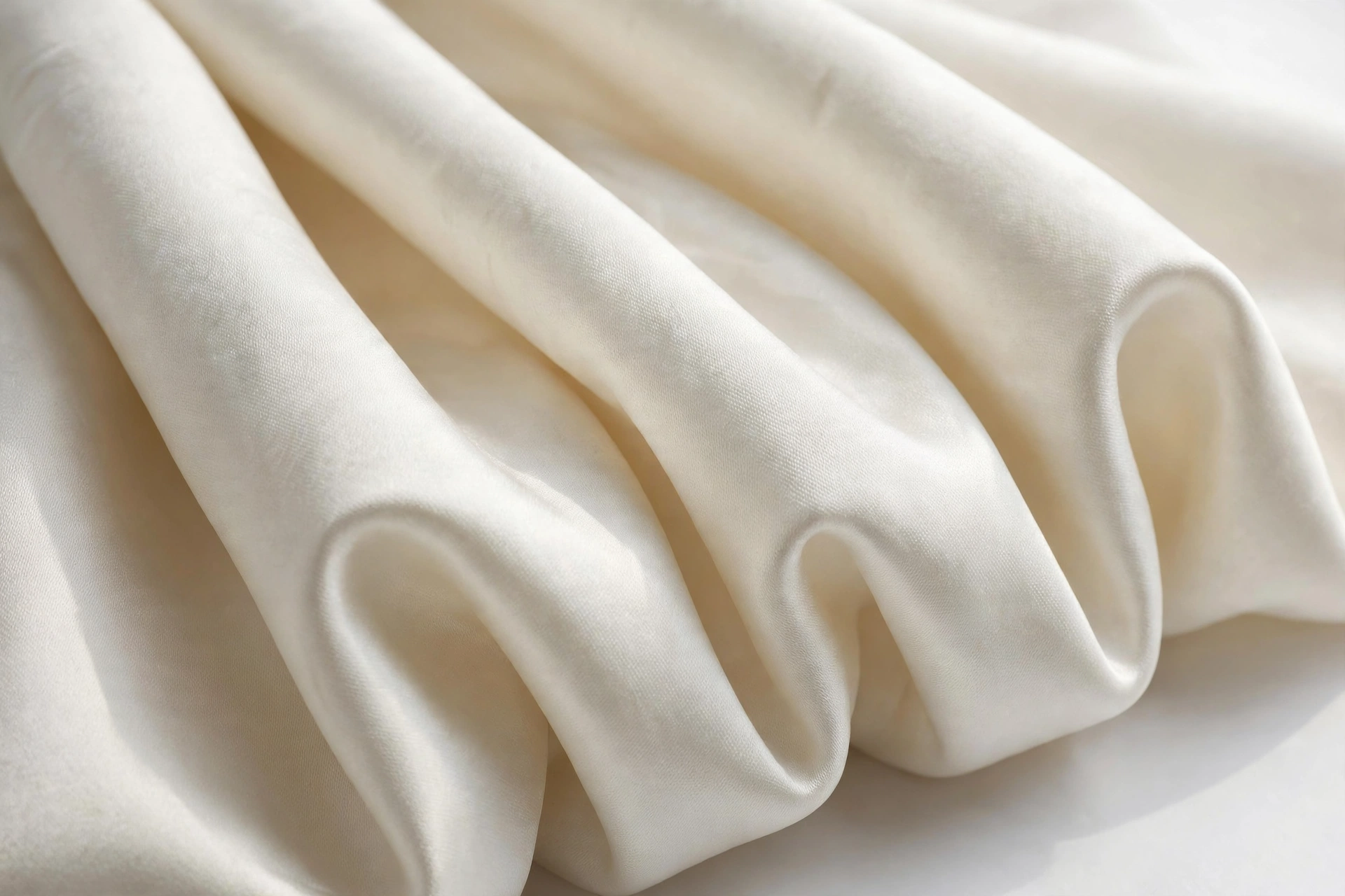 Close-up of ivory duchess satin's soft pearly sheen