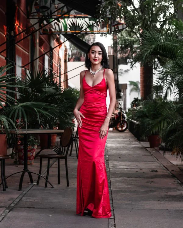 Woman wearing a red satin slip dress outdoors