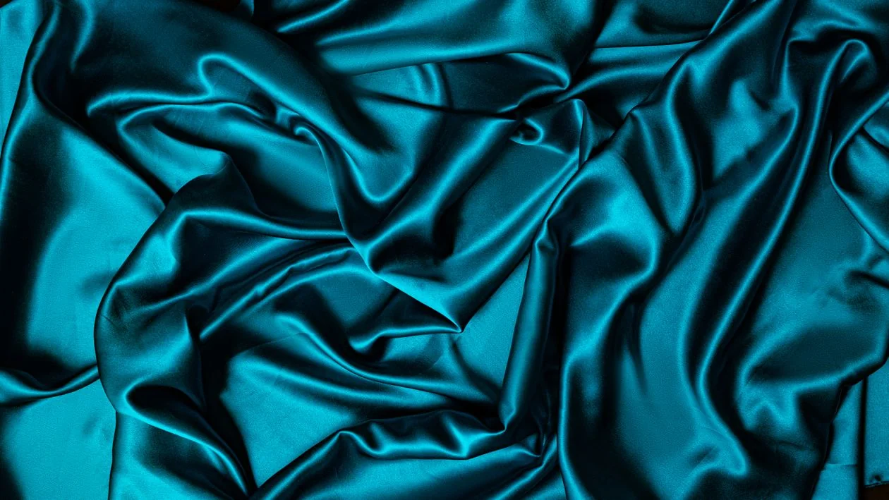 Close-up of satin fabric showing folds and sheen