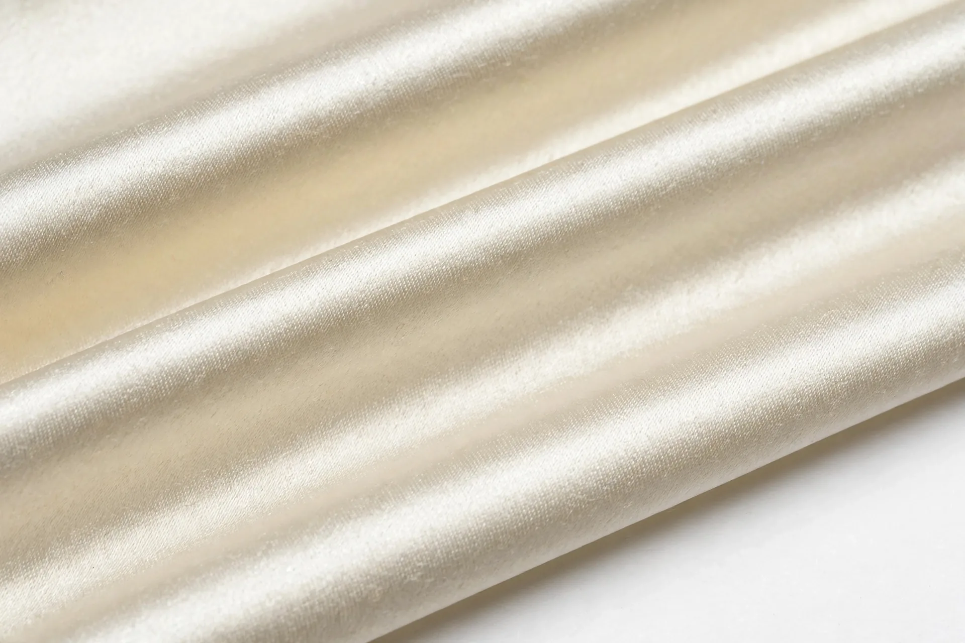 Close-up of ivory silk satin showing smooth weave floats